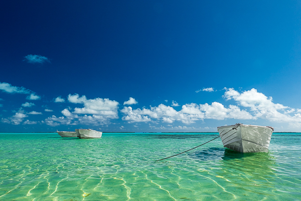small boats anchored in a lagoon in Tahiti