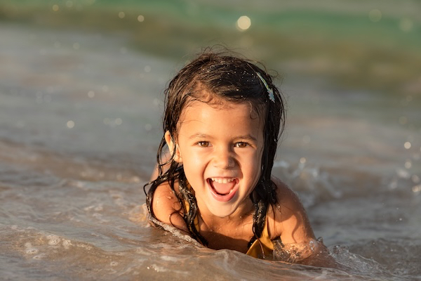 child swimming in ocean