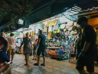 Tourists in a market in Thailand at night