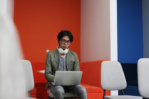 man working on computer in airport